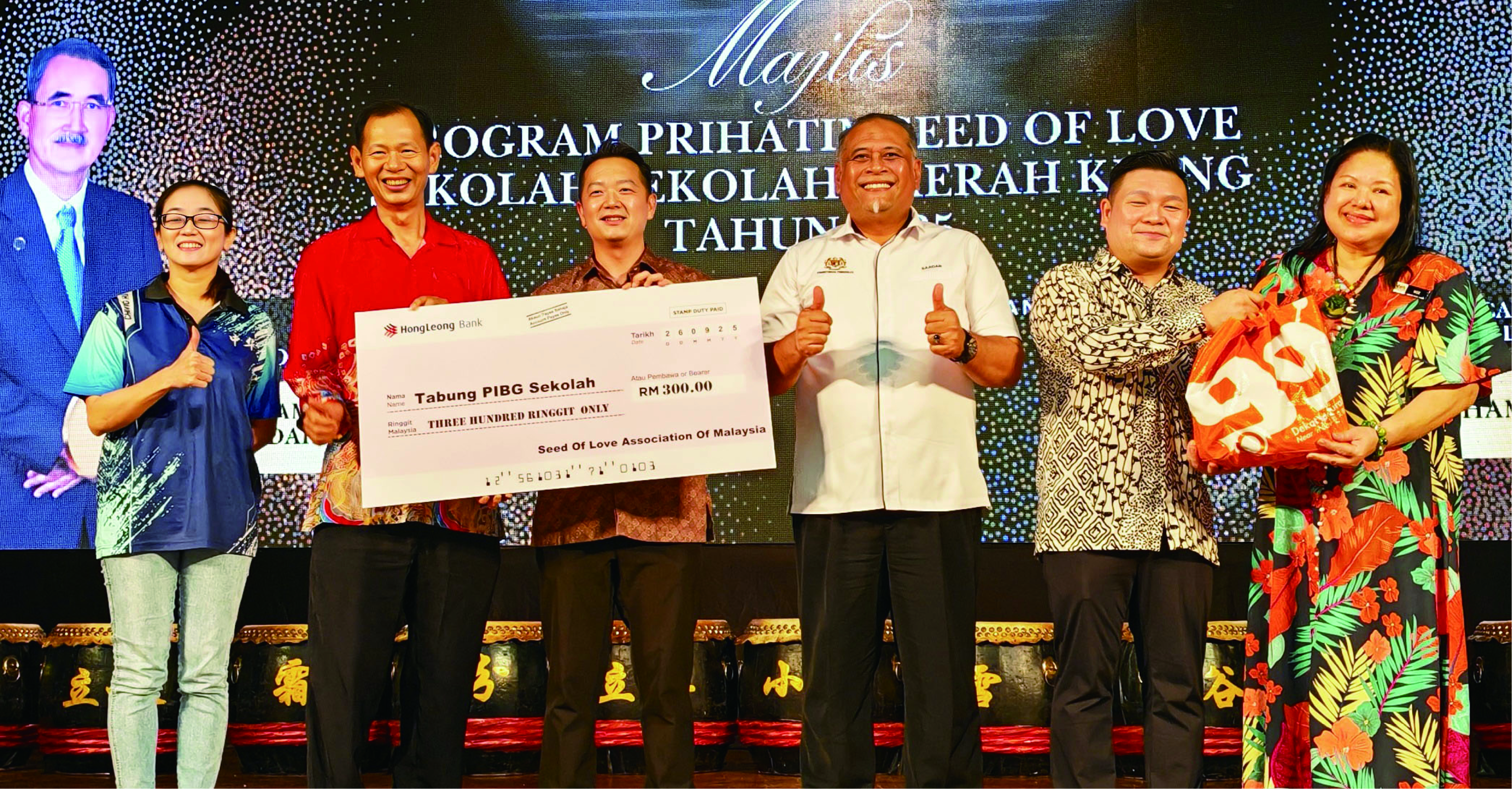 ■郑复鸿(左3)移交模拟支票给巴生中华小学校长颜敬全(左2),左为家协财政谢诗怡、右起为黄会萍副校长、邱明耀及沙阿丹。